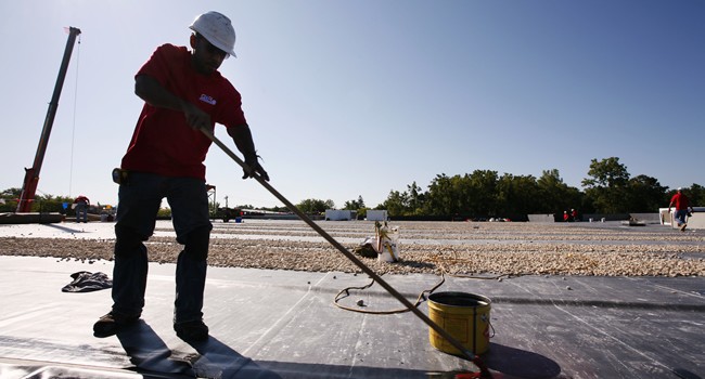 Roofer working on a flat commercial roof